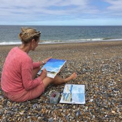 Tracey Ross painting outside at Cley Beach UK.