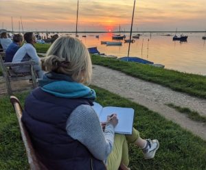 Tracey Ross sketching a sinking sunset on the Norfolk coast.